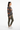 Female model in olive green joggers and white sneakers