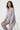 Woman sitting elegantly in satin pajama top