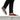 Man wearing colorful lace-ups with cargo pants on ledge