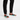 Man wearing colorful lace-ups with track pants, standing pose