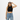 Woman wearing natural/black snapback with crop top and high-waisted jeans