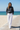 Blonde model — white linen wide-leg pants, boardwalk
