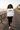 Female 4 — black joggers, boardwalk