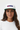 Female model close-up white cap confident