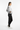Female model, side angle, black track pants