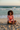 Model seated on beach
